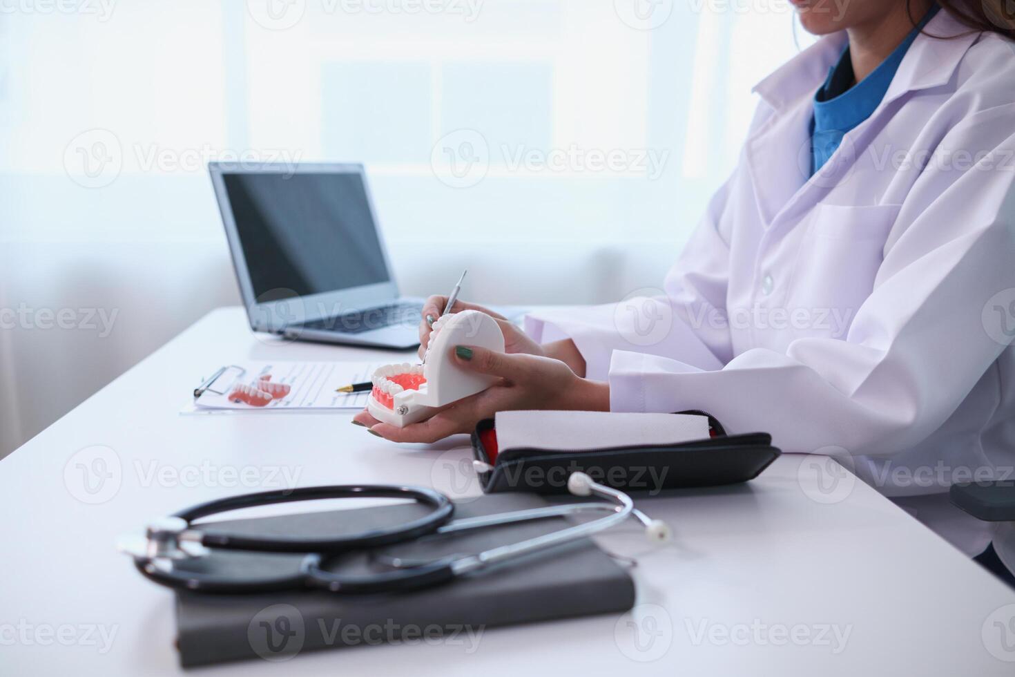 woman consults dentist about her toothache for treatment in dental clinic and dentist gives advice on right symptoms and treatment method for patient. concept consulting dentist about dental treatment photo
