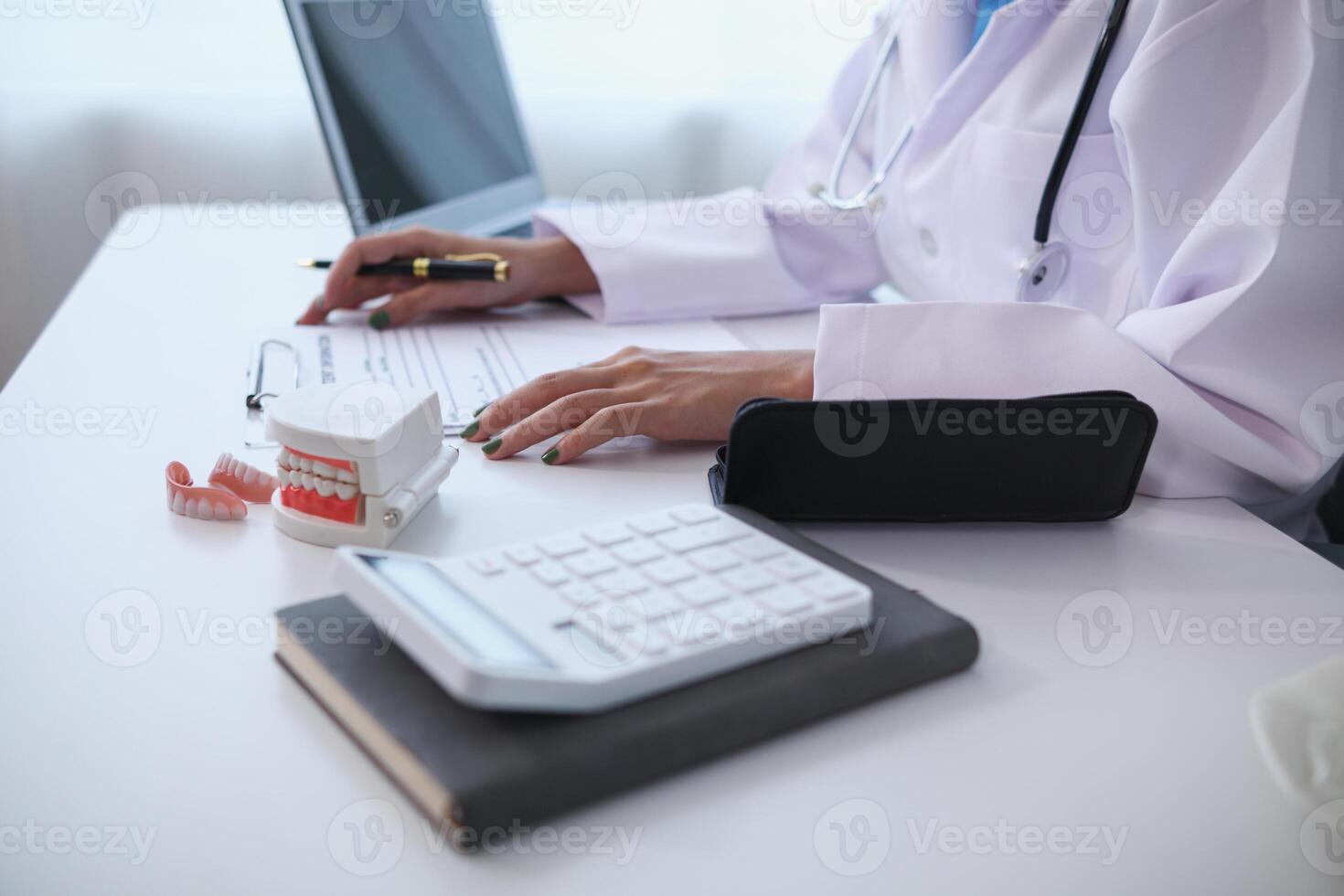 woman consults dentist about her toothache for treatment in dental clinic and dentist gives advice on right symptoms and treatment method for patient. concept consulting dentist about dental treatment photo
