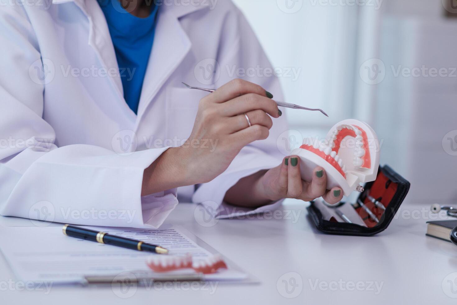 woman consults dentist about her toothache for treatment in dental clinic and dentist gives advice on right symptoms and treatment method for patient. concept consulting dentist about dental treatment photo