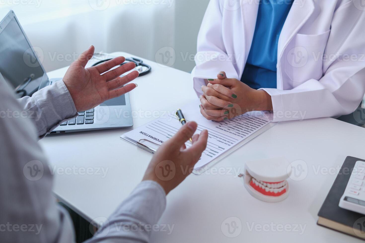 woman consults dentist about her toothache for treatment in dental clinic and dentist gives advice on right symptoms and treatment method for patient. concept consulting dentist about dental treatment photo