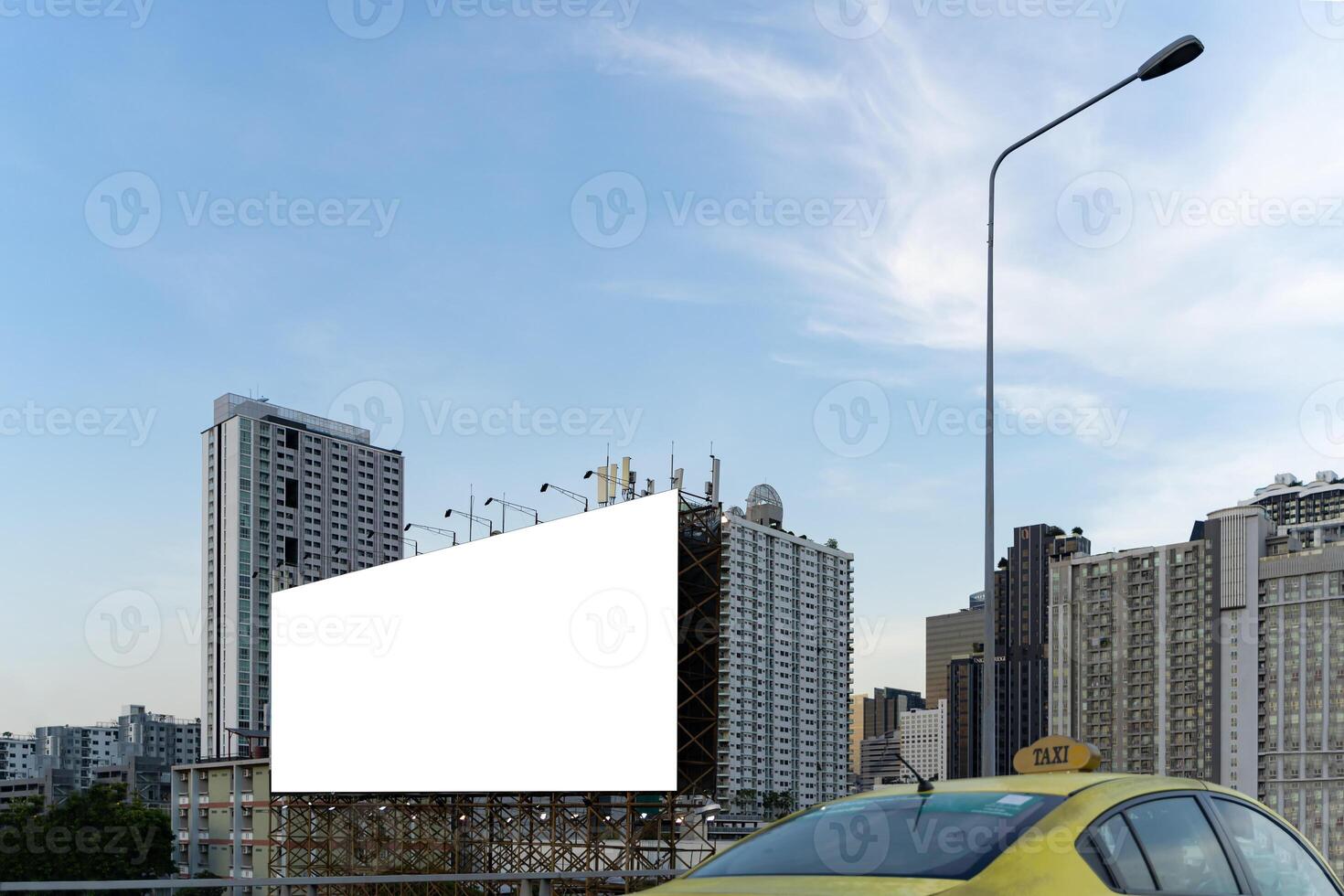 Large empty billboard ads along city highways on the background of a blue sky with beautiful clouds can be used for product display. Outdoor advertising posters for city streets photo