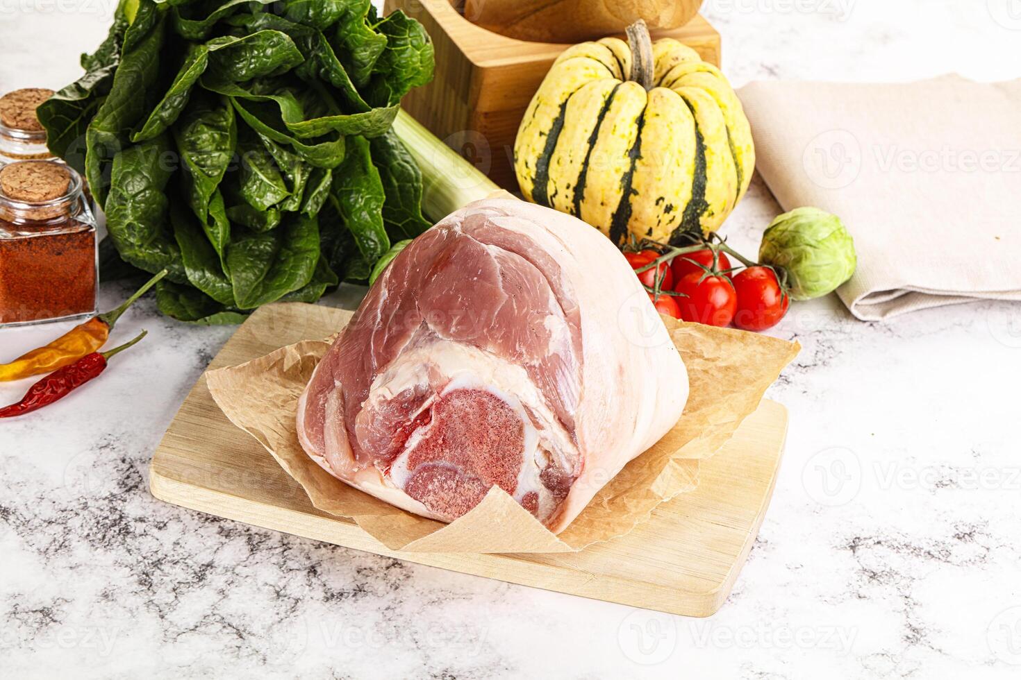 Uncooked raw pork knuckle with spices photo