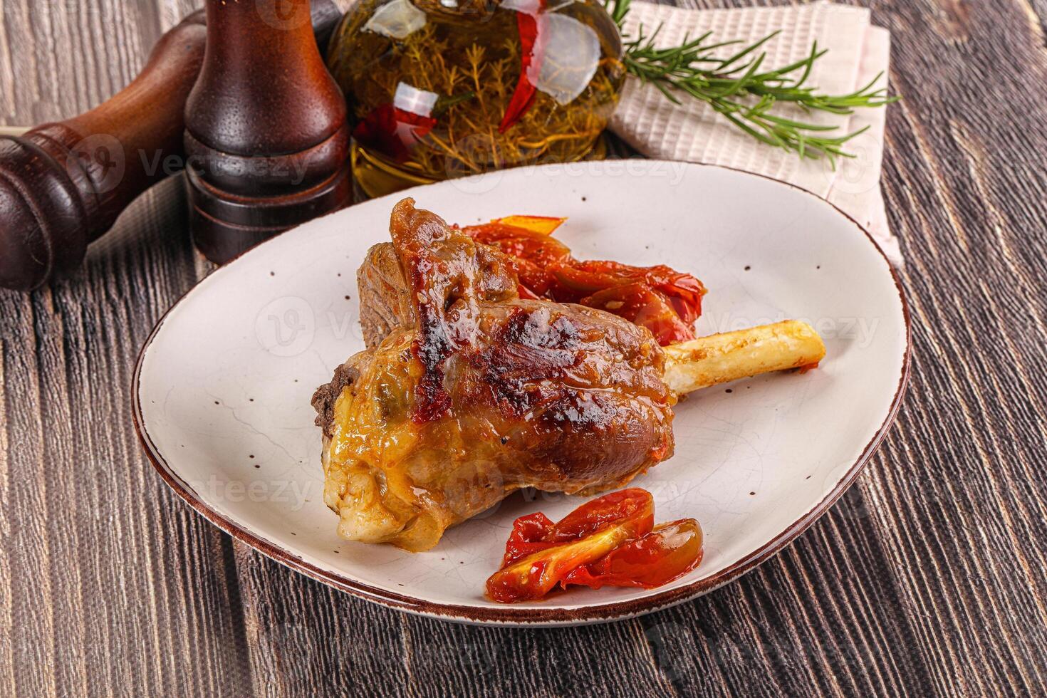 Baked lamb shank with vegetables photo