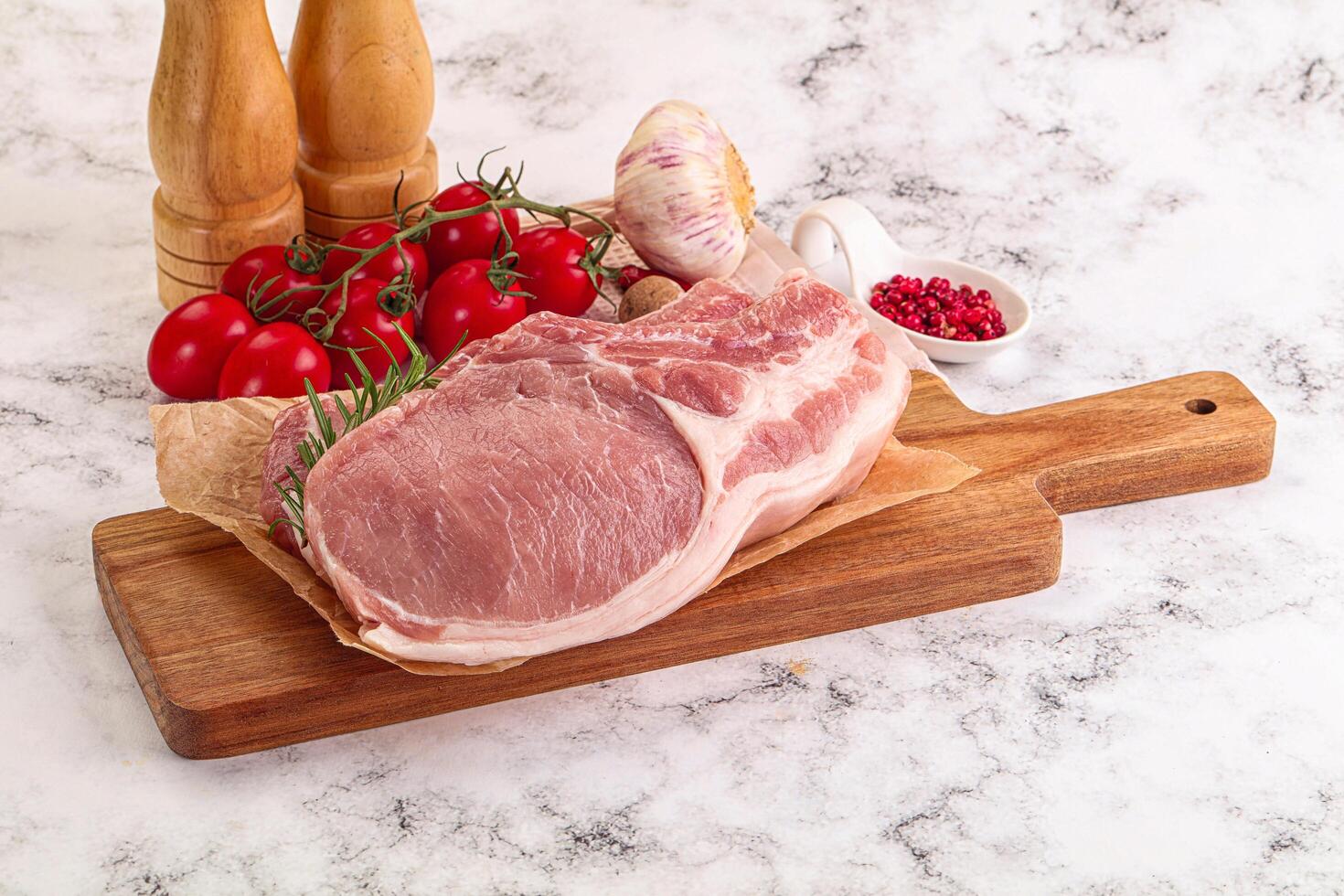 Raw potk loin steak with bone photo