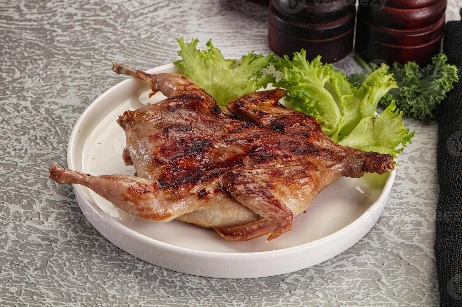 Grilled quail in the plate photo