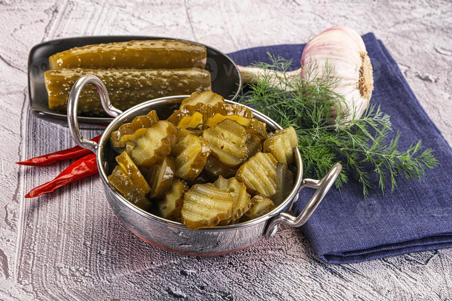 Sliced marinated cucumbers in the bowl photo