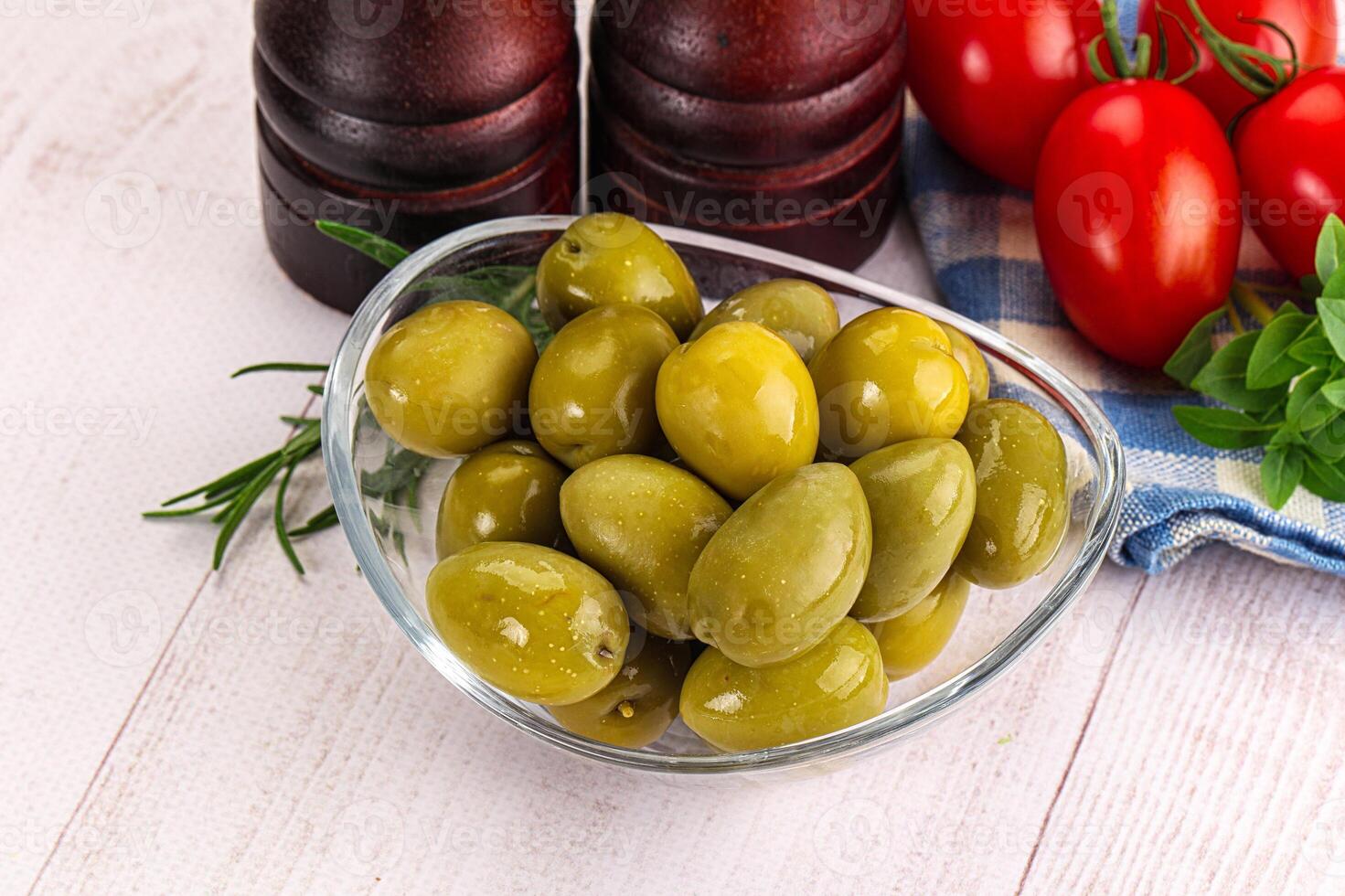 Green marinated olives in the bowl photo