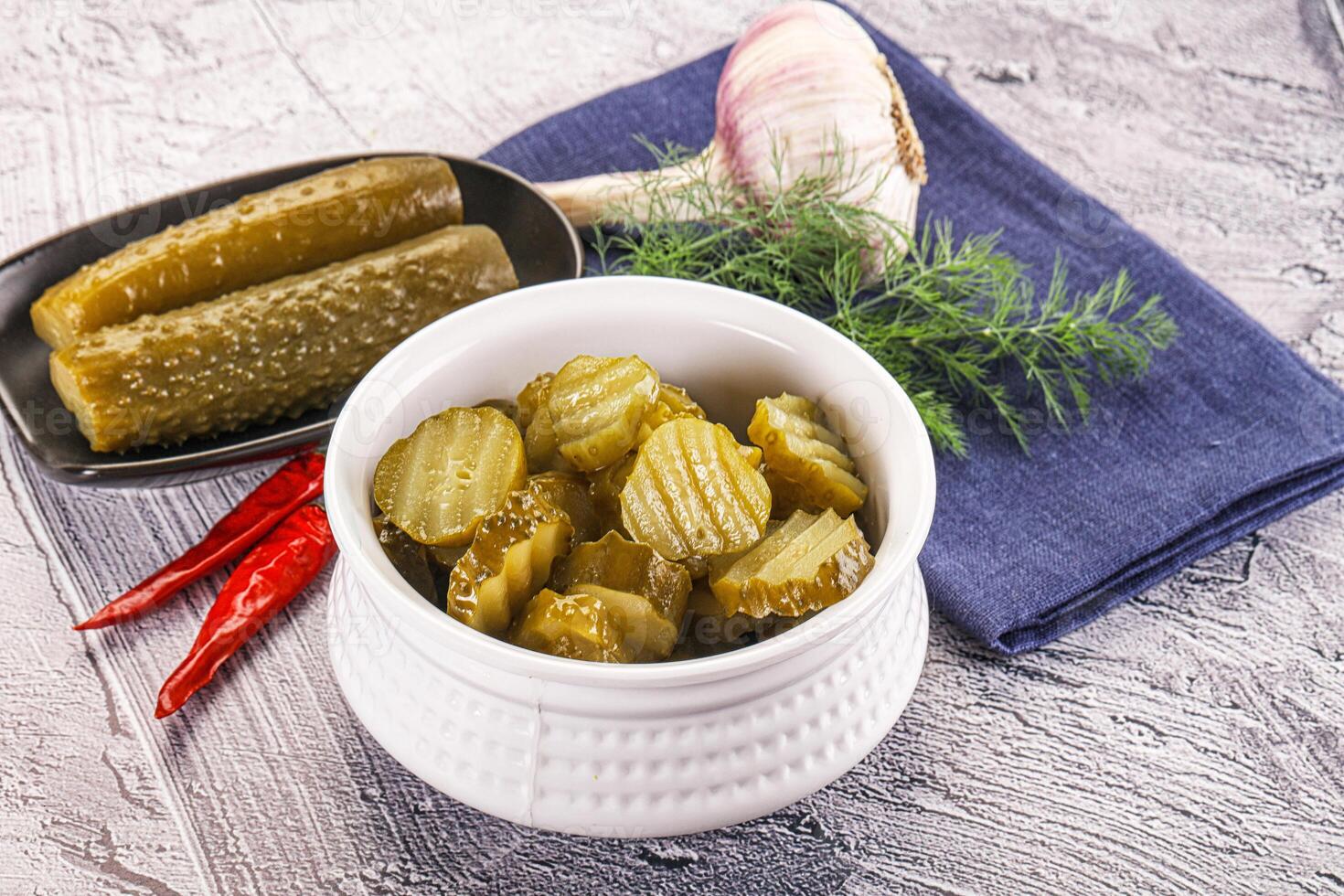 Sliced marinated cucumbers in the bowl photo