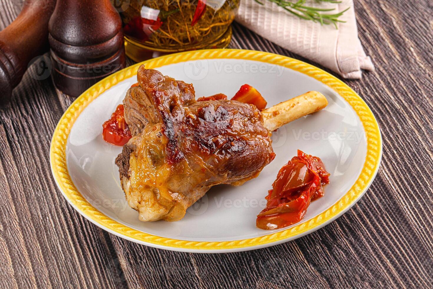 Baked lamb shank with vegetables photo