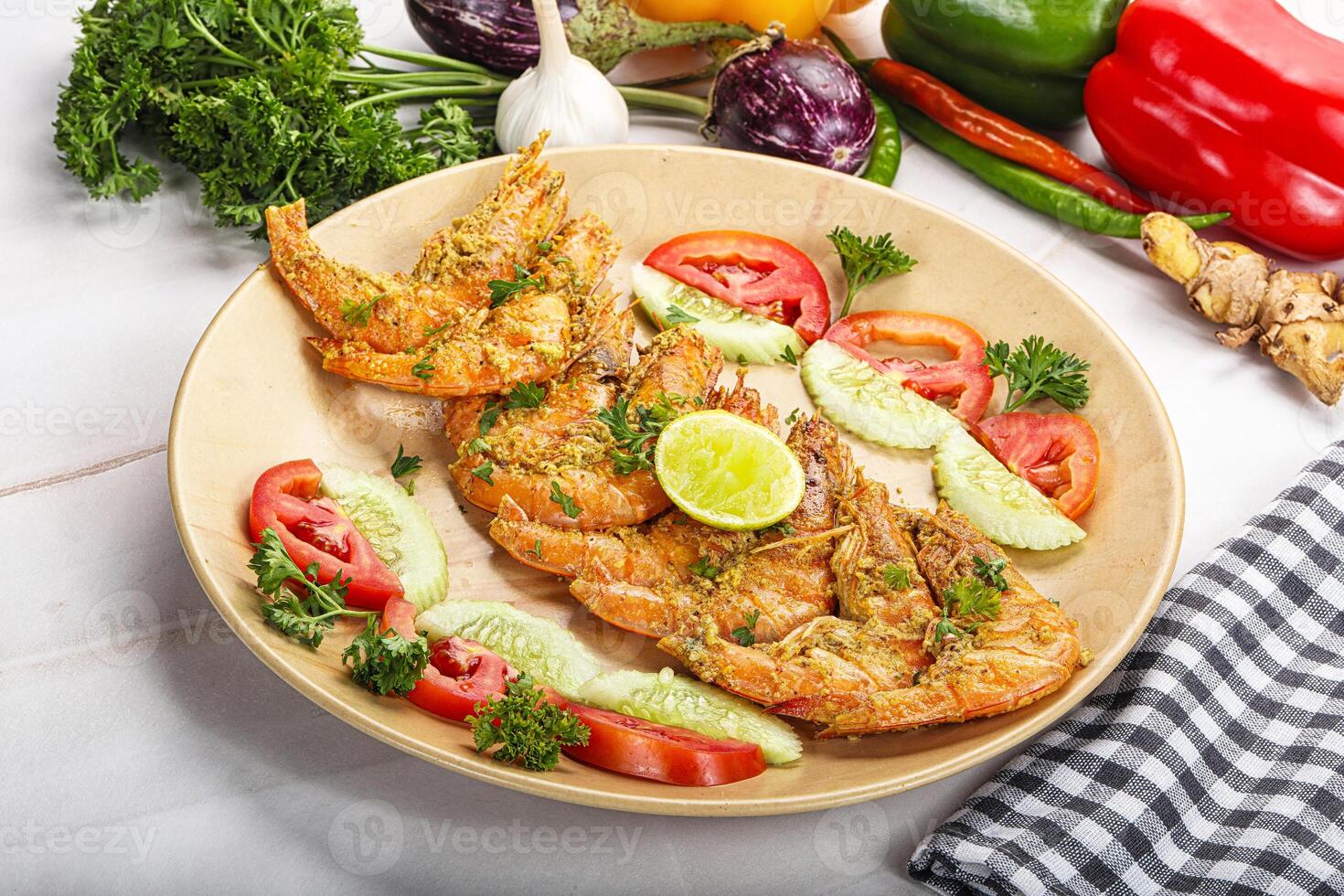 Grilled prawn served lime and vegetables photo