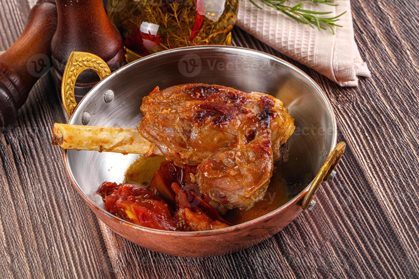 Baked lamb shank with vegetables photo