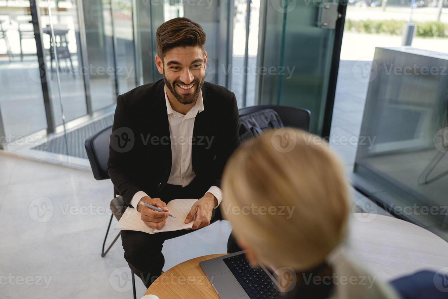 Business partners have meeting in cafe to solve biz issues and work with documets photo