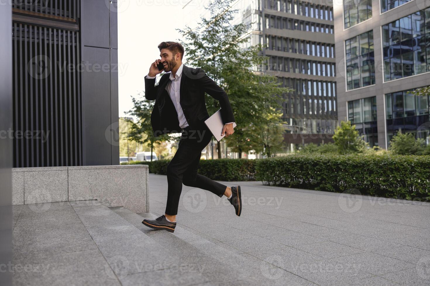 Businessman run and hurry up to office while talking phone with customers photo