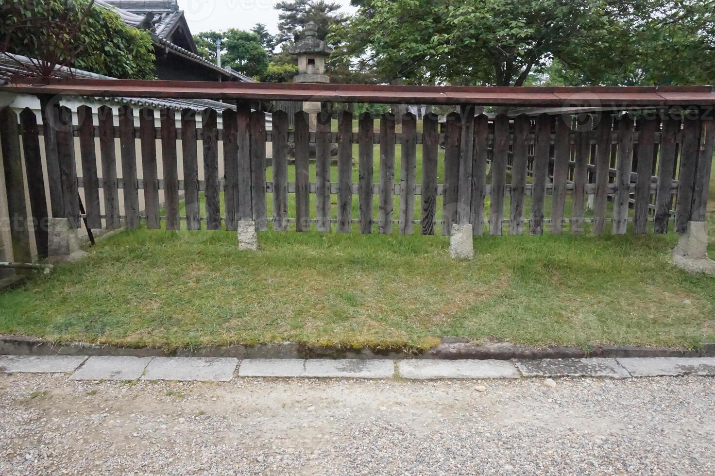 A wooden fence with a wooden gate in front of it photo