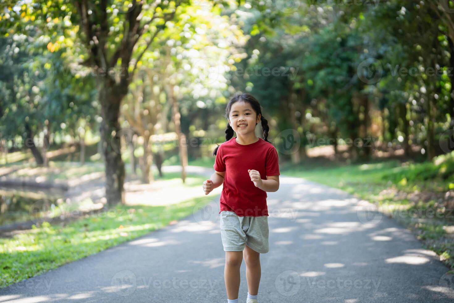 Happy baby Asian girl smiling. little girl running and smiling at sunset happy baby girl smiling. little baby running at sunset. cute baby running at playground garden. photo
