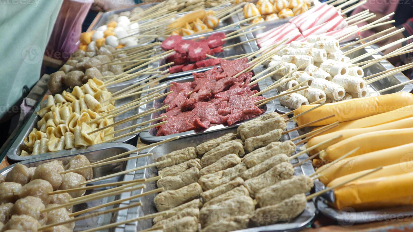 Various kinds of satay are displayed in festival night street food photo