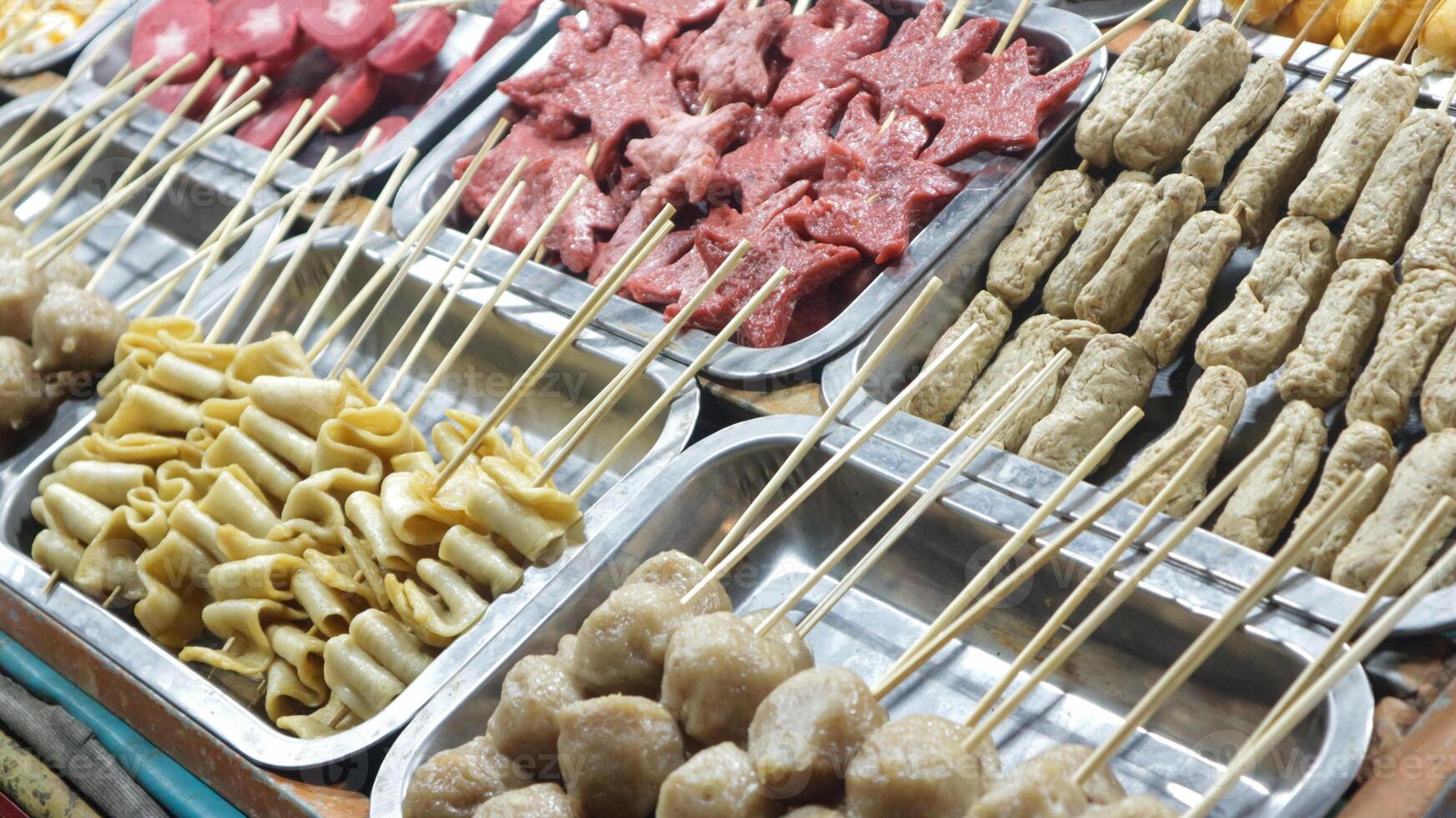 Various kinds of satay are displayed in festival night street food photo