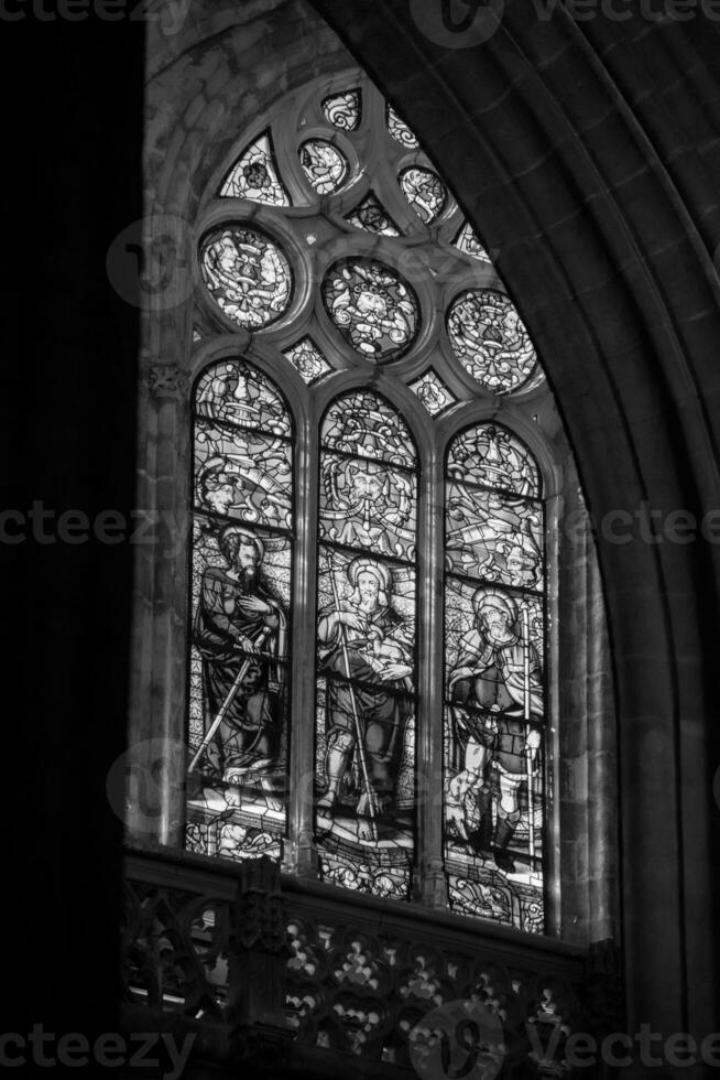 a black and white image of stained windows in a church at the heart of Marbella photo
