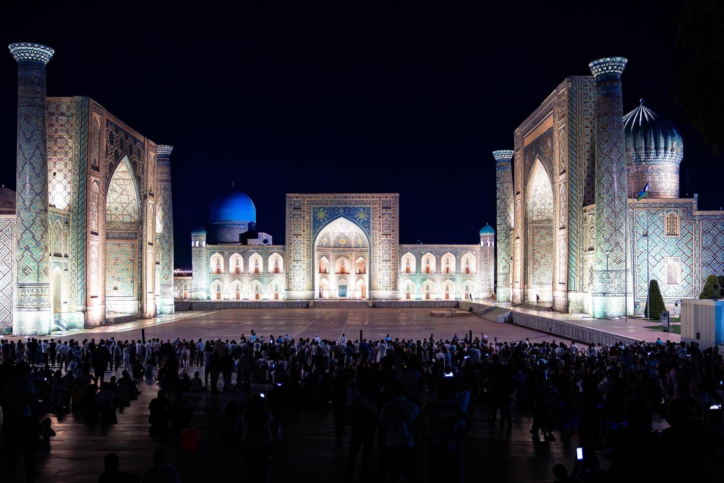 Samarkand, Uzbekistan-august 12, 2023-People in Registan Square watching a light show that illuminates all the buildings in the square during a summer night photo
