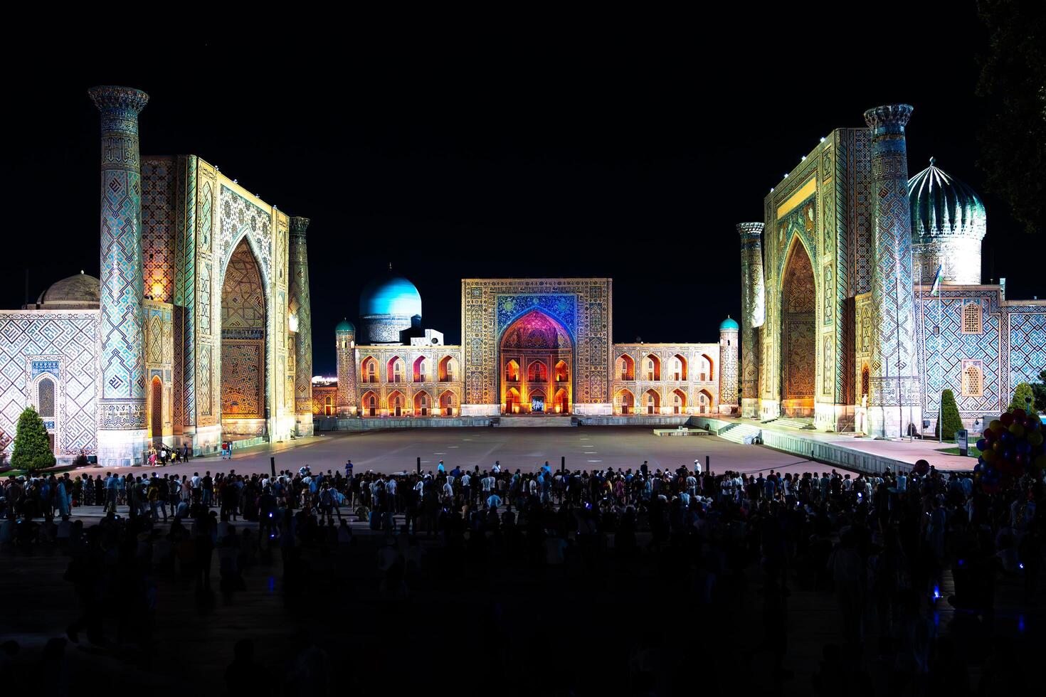 Samarkand, Uzbekistan-august 12, 2023-People in Registan Square watching a light show that illuminates all the buildings in the square during a summer night photo