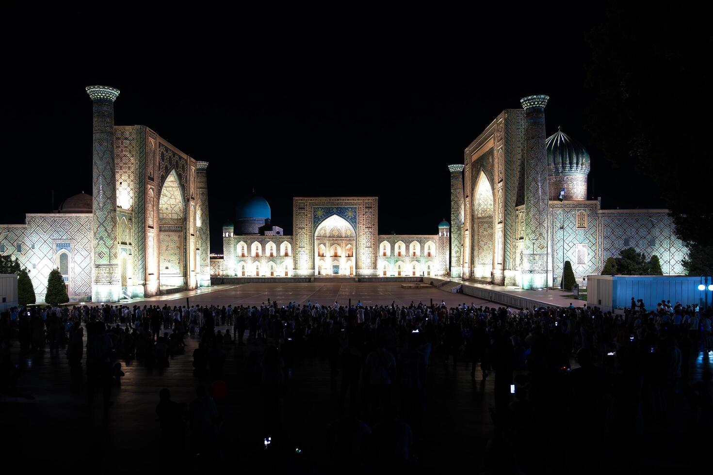 Samarkand, Uzbekistan-august 12, 2023-People in Registan Square watching a light show that illuminates all the buildings in the square during a summer night photo