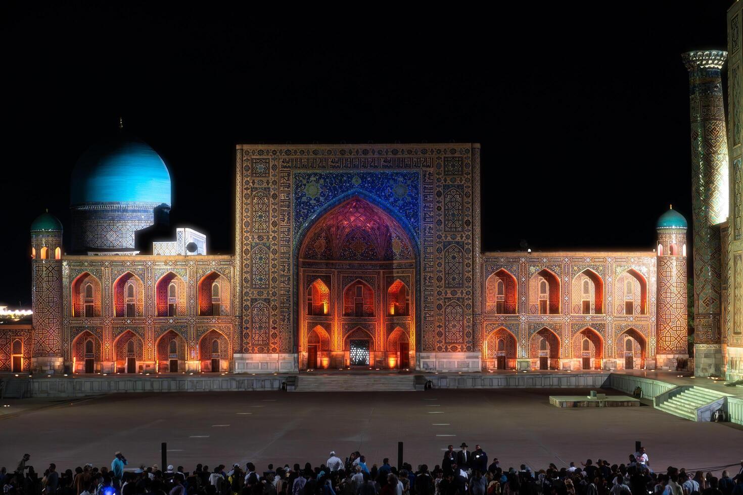 Samarkand, Uzbekistan-august 12, 2023-People in Registan Square watching a light show that illuminates all the buildings in the square during a summer night photo