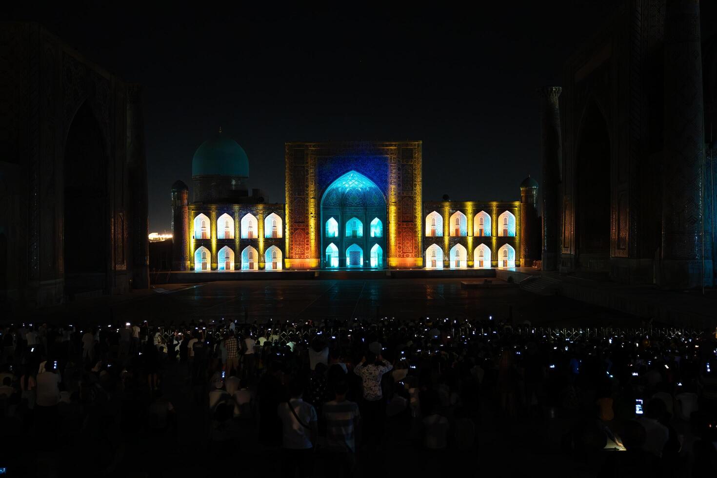 Samarkand, Uzbekistan-august 12, 2023-People in Registan Square watching a light show that illuminates all the buildings in the square during a summer night photo