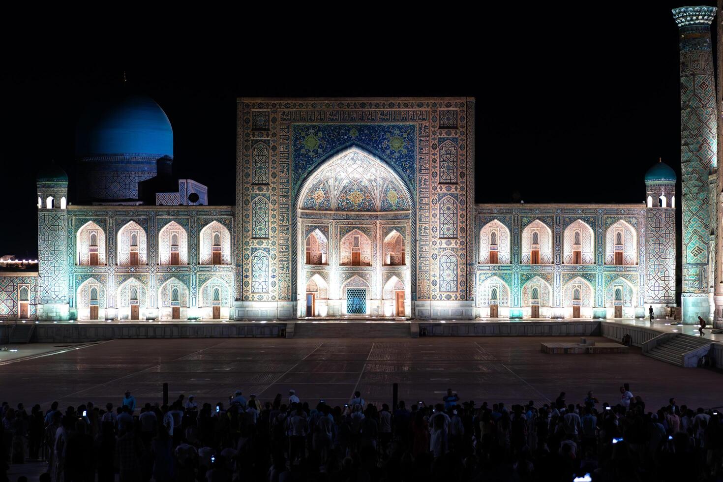 Samarkand, Uzbekistan-august 12, 2023-People in Registan Square watching a light show that illuminates all the buildings in the square during a summer night photo