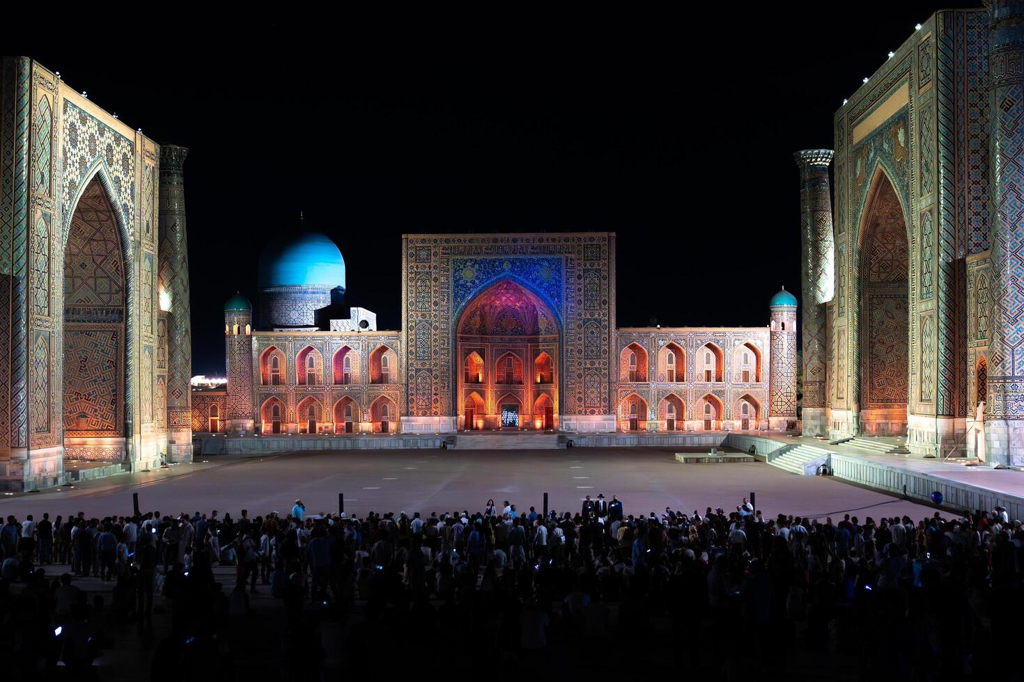 Samarkand, Uzbekistan-august 12, 2023-People in Registan Square watching a light show that illuminates all the buildings in the square during a summer night photo