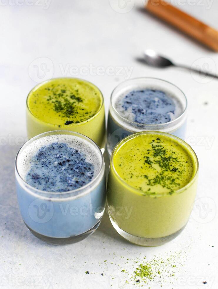 three cups of matcha with blueberries and green tea photo
