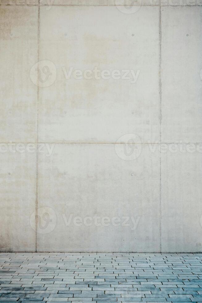 empty concrete wall with a brick floor photo