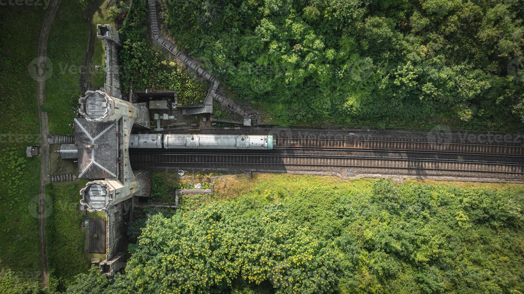 Rail track tunnel with castle looking house on top, in a green hill, East Sussex, UK photo