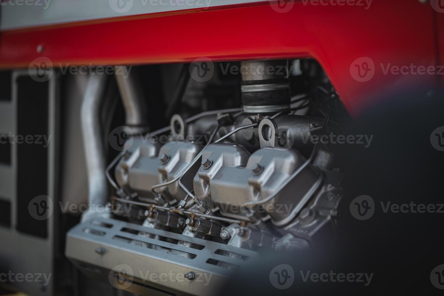 Old tractor diesel engine on a display under the motor cover. photo