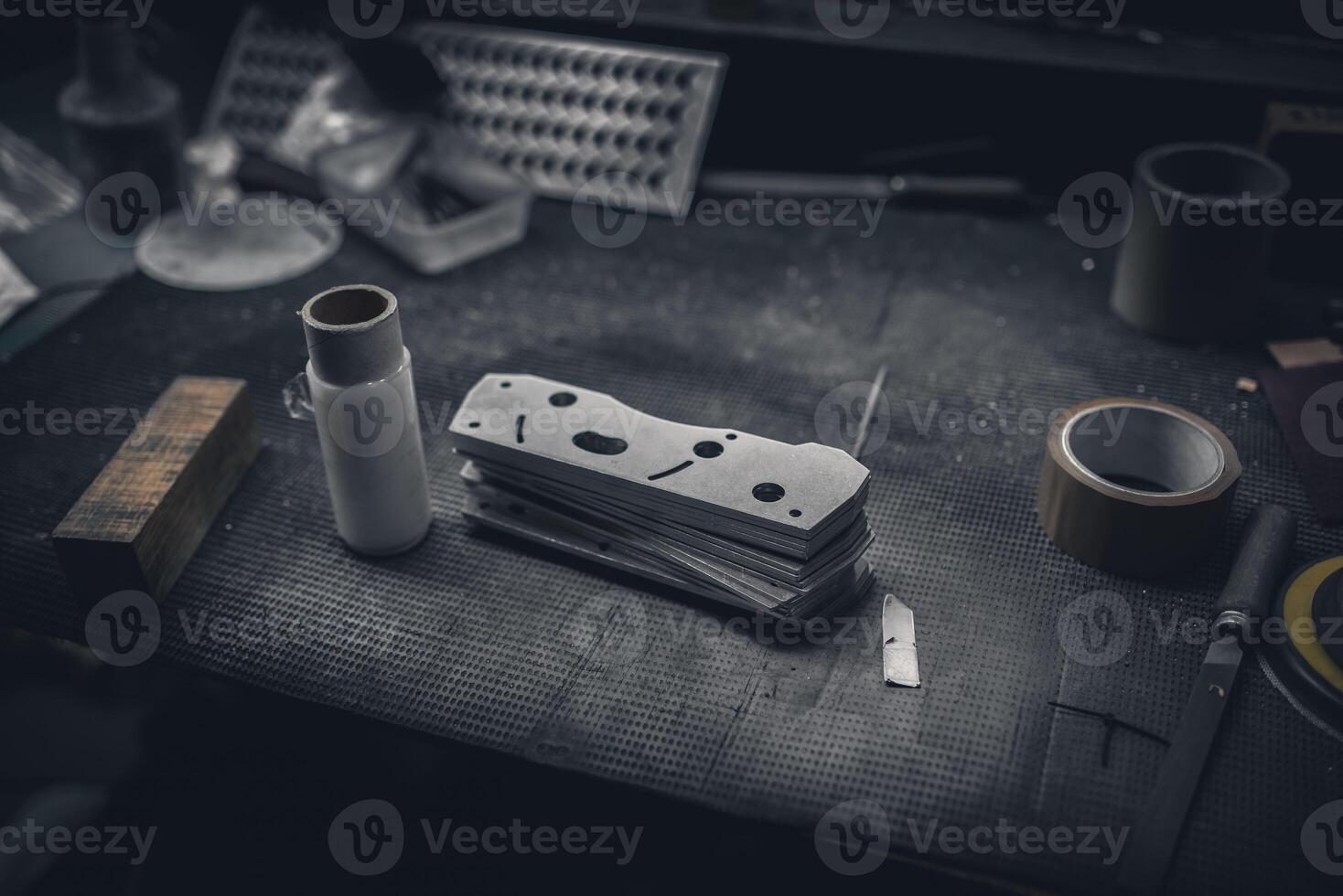 Flat metal parts during production on work table in a factory. photo