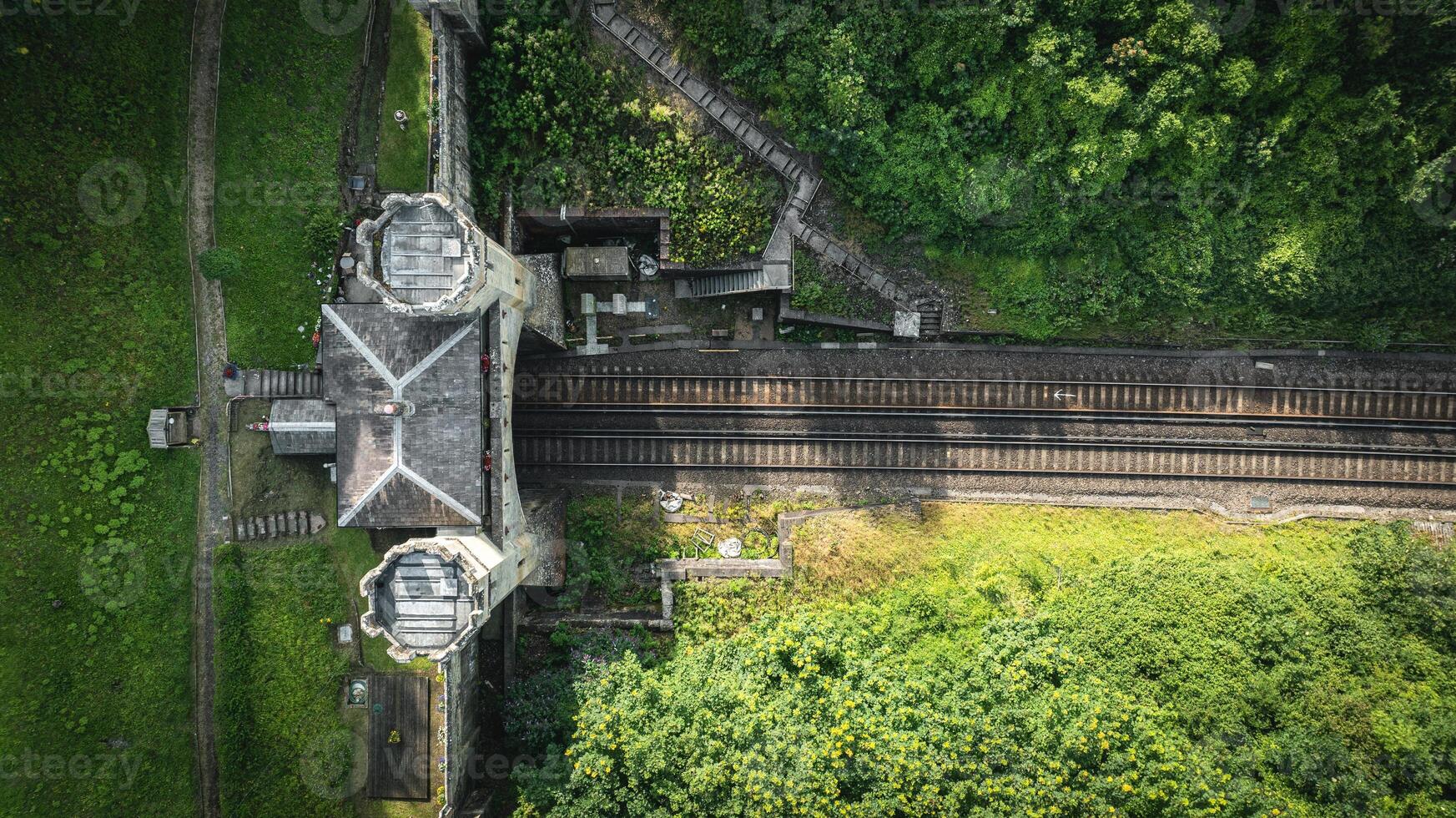 Rail track tunnel with castle looking house on top, in a green hill, East Sussex, UK photo