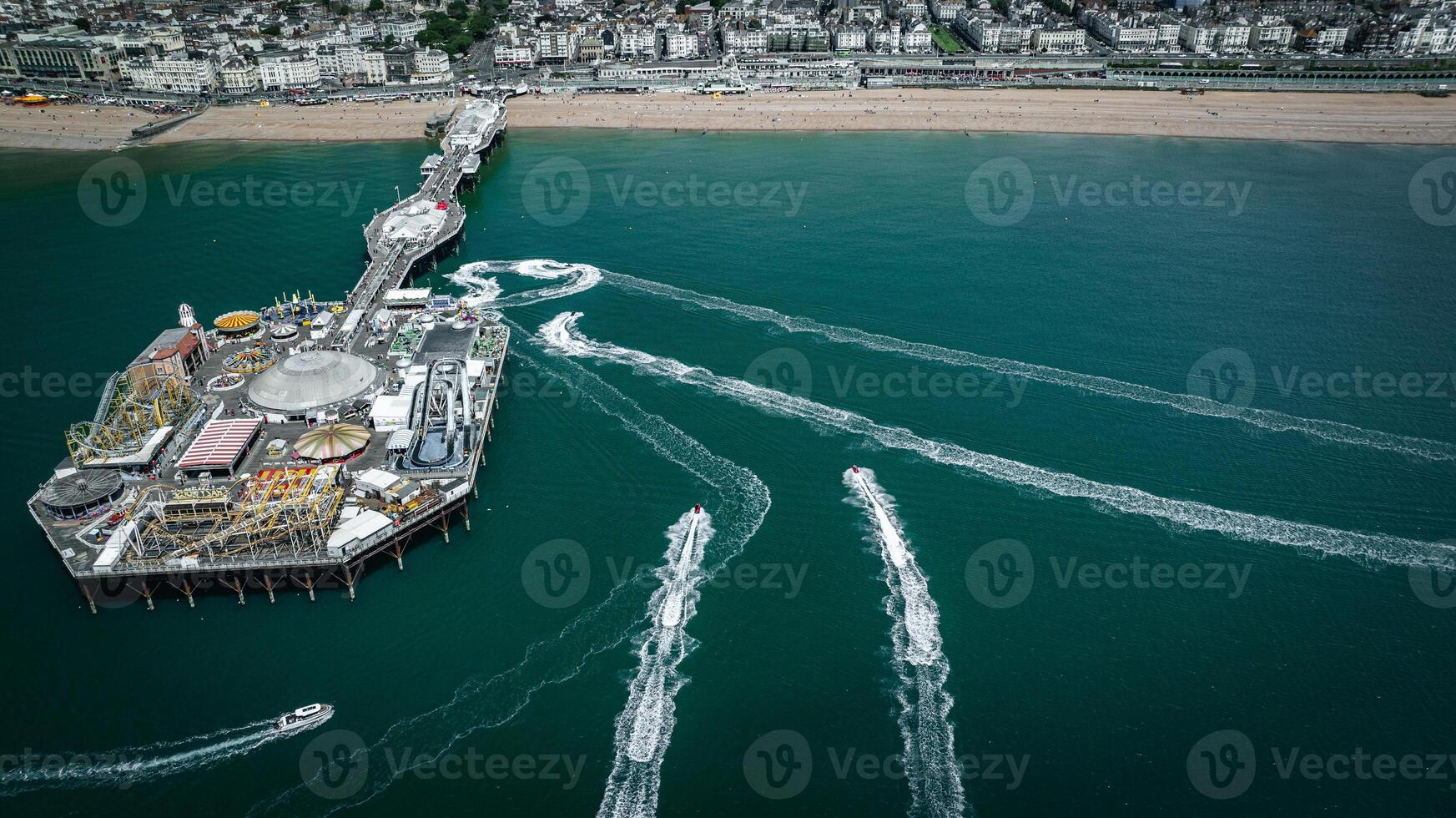 Aerial view of jet ski around Brighton pier on a sunny summer day, East Sussex, UK photo