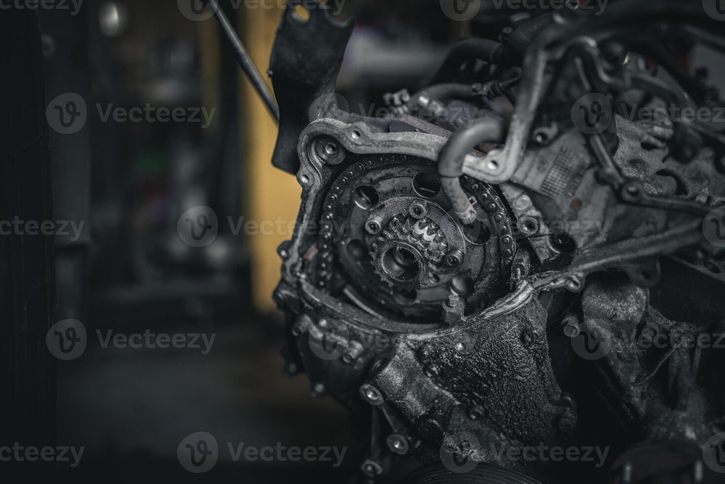 Timing cover off the engine exposing chain and cogs, automotive repair. photo