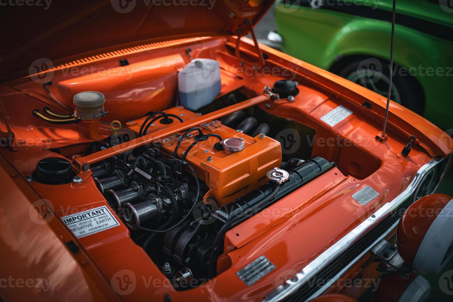 Open bonnet of a classic car displaying fully restored engine compartment. photo