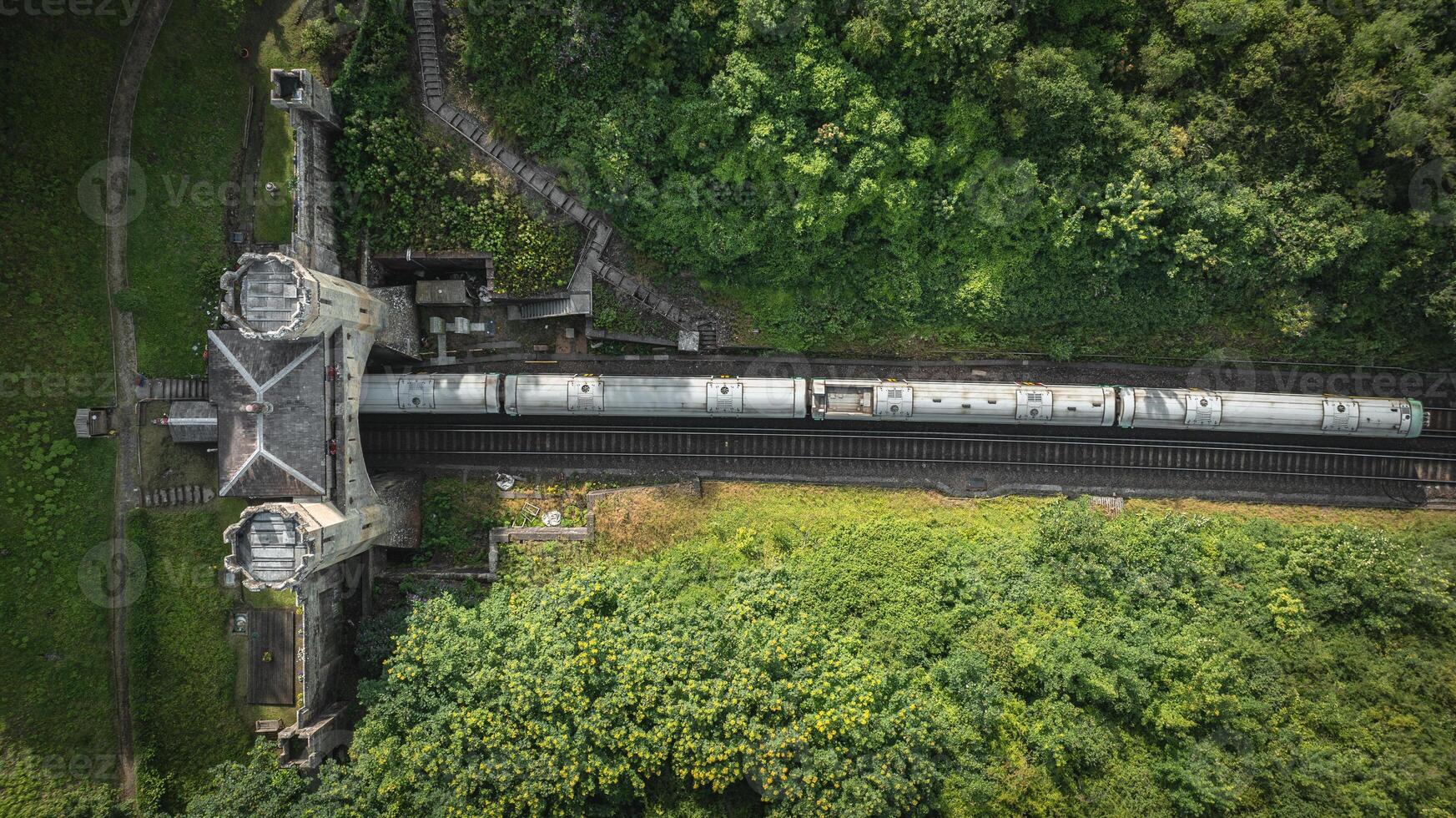Rail track tunnel with castle looking house on top, in a green hill, East Sussex, UK photo