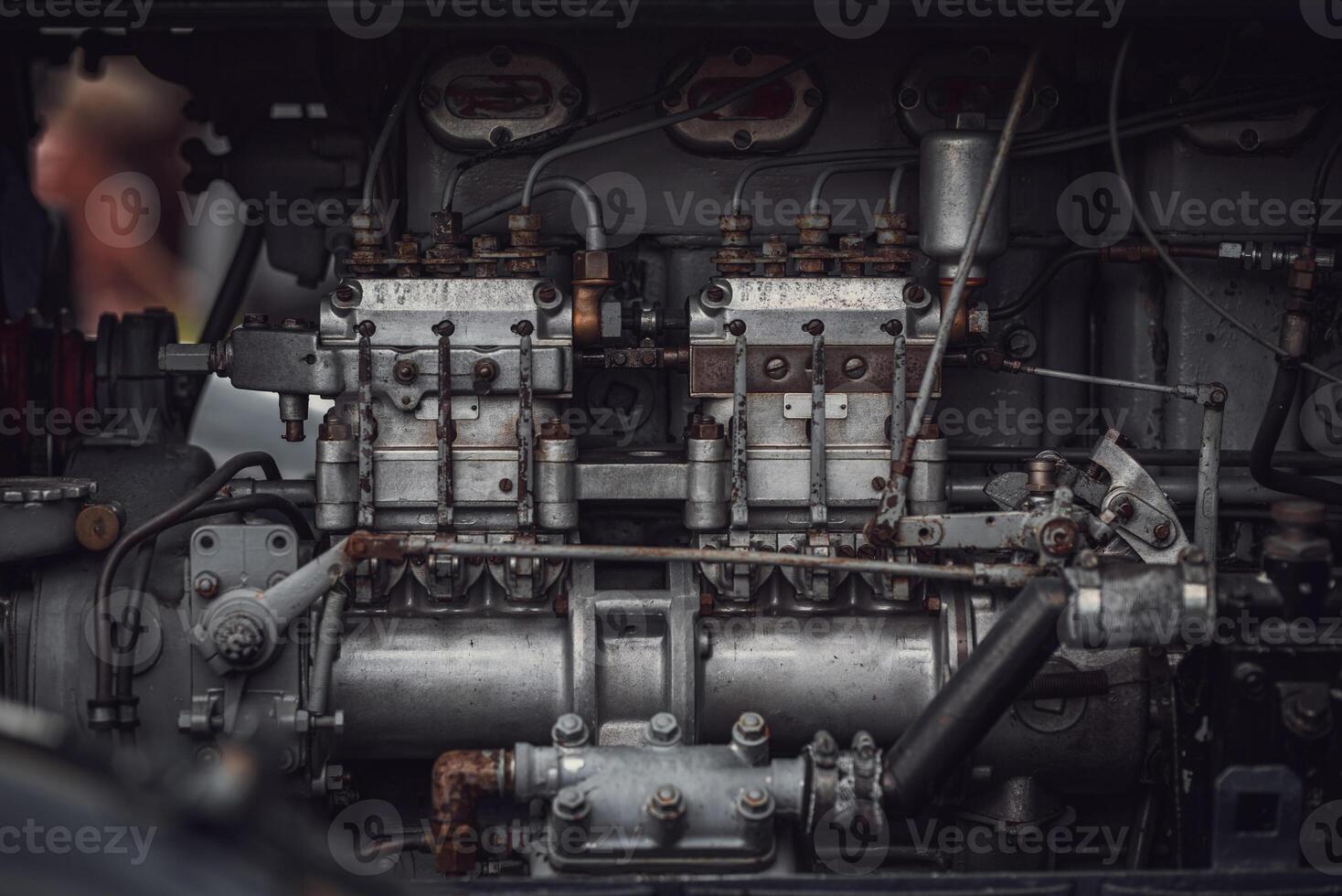 Old tractor diesel engine on a display under the motor cover. photo