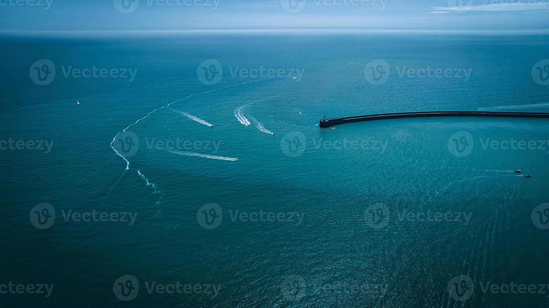 Aerial view of few boats in blue waters of Newhaven, East Sussex, UK photo