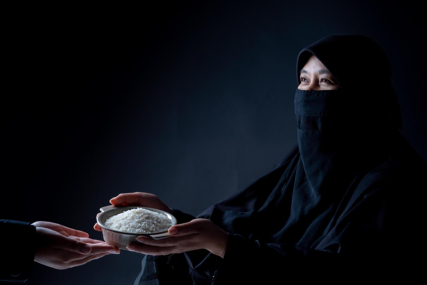 Hands are holding a pile of grain to zakat, the Islamic zakat concept. Muslims help the poor and needy. Conceptual shoot for property, income, and fitrah zakat. photo
