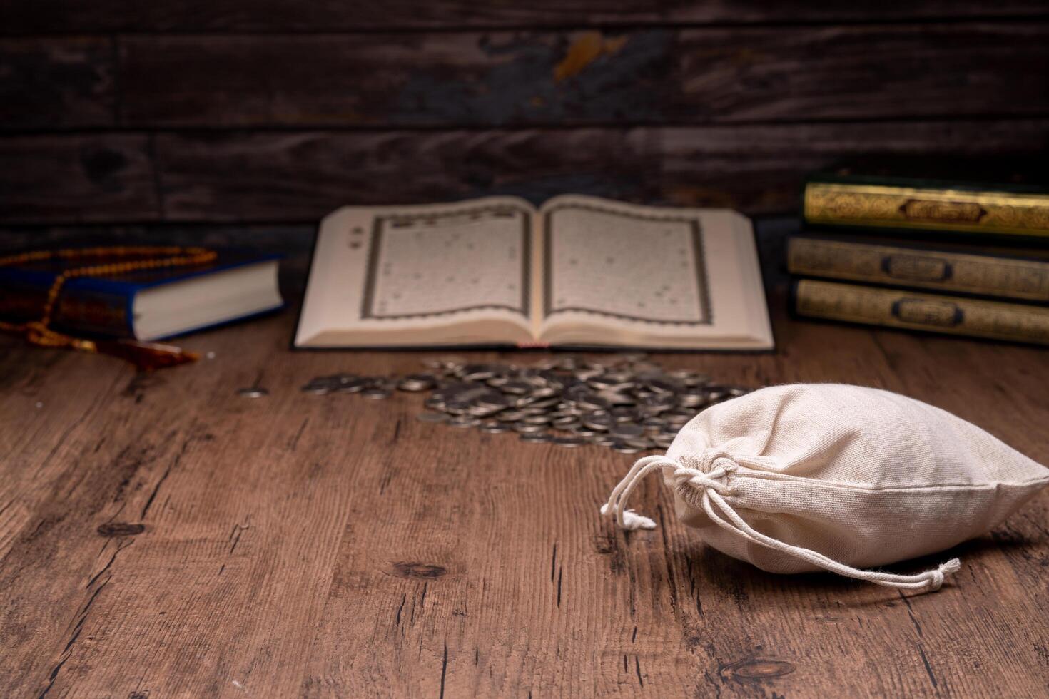 Hands holding a wooden bowl of rice grains and money bag for zakat, Islamic zakat concept. Muslims help the poor and needy. Conceptual shoot for property, income, and fitrah zakat. photo