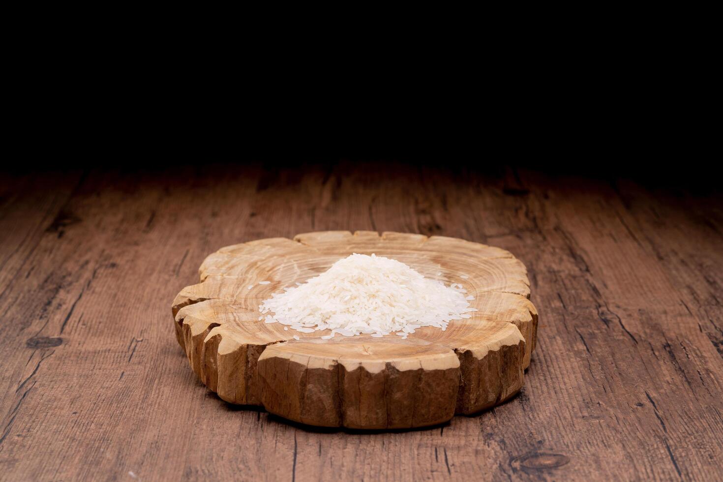 Hands holding a wooden bowl of rice grains and money bag for zakat, Islamic zakat concept. Muslims help the poor and needy. Conceptual shoot for property, income, and fitrah zakat. photo