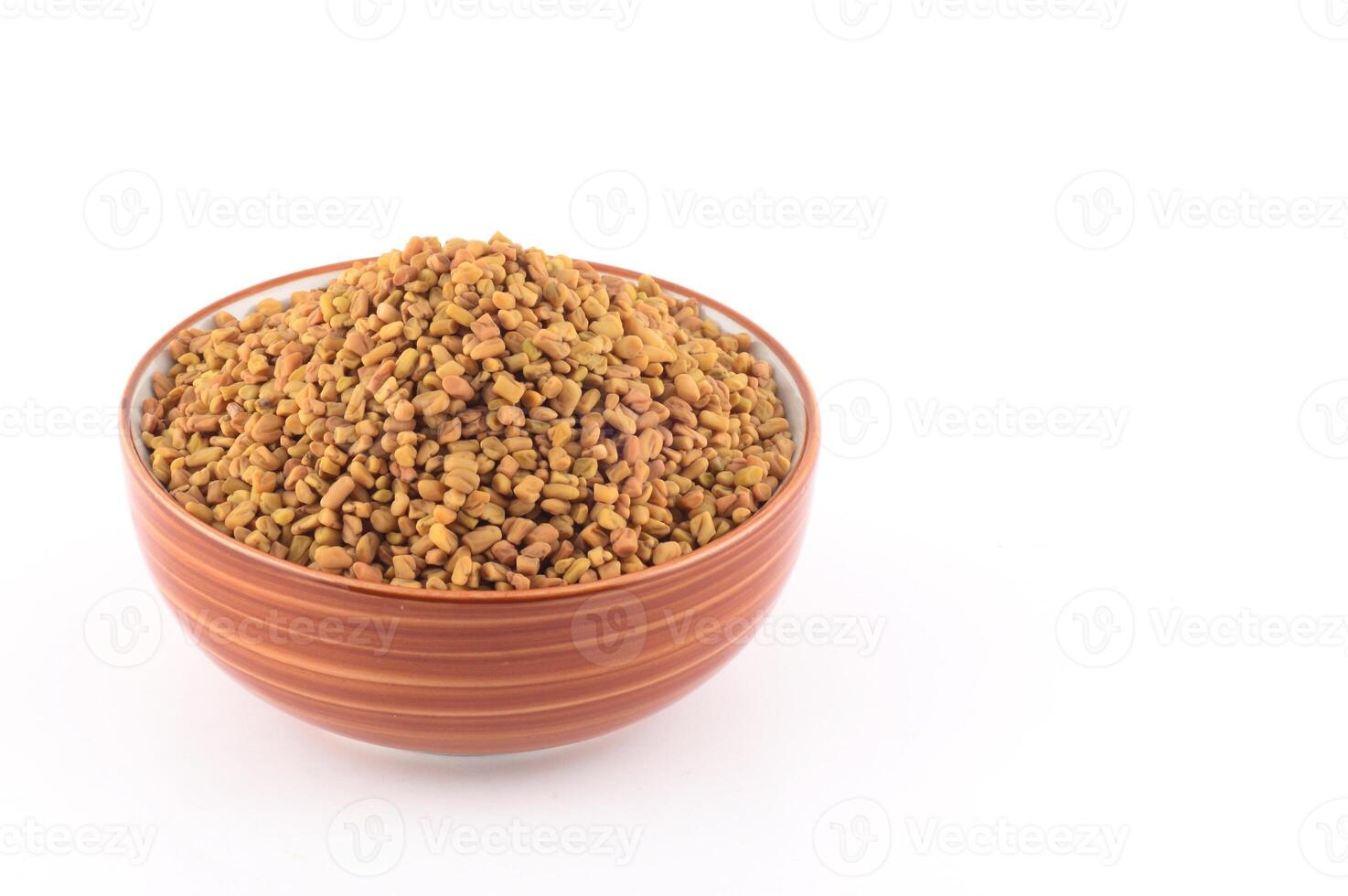 Fenugreek seeds in bowl isolated on white background photo