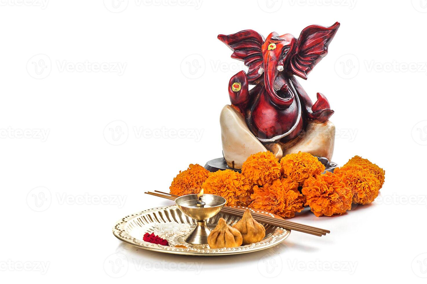 Hindu God Ganesha. Statue of Lord Ganesha. Worship arrangement on white background. photo