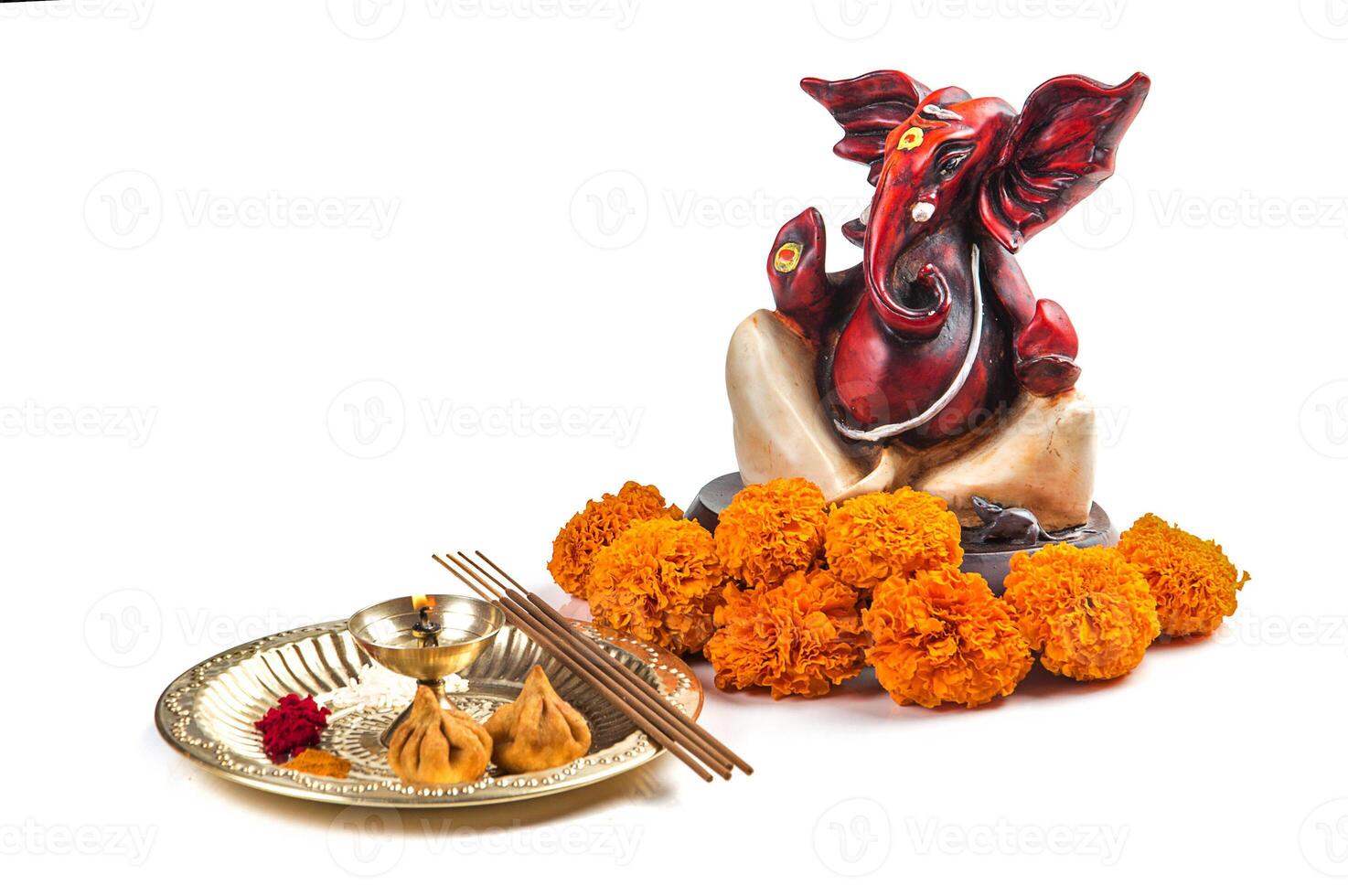 Hindu God Ganesha. Statue of Lord Ganesha. Worship arrangement on white background. photo