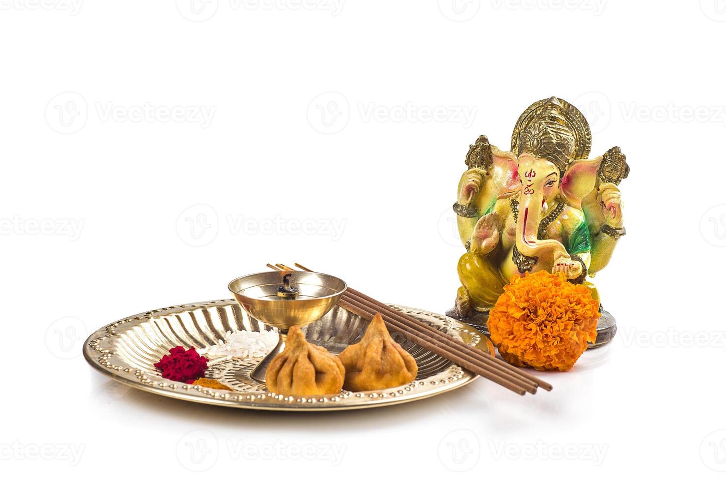Hindu God Ganesha. Statue of Lord Ganesha. Worship arrangement on white background. photo