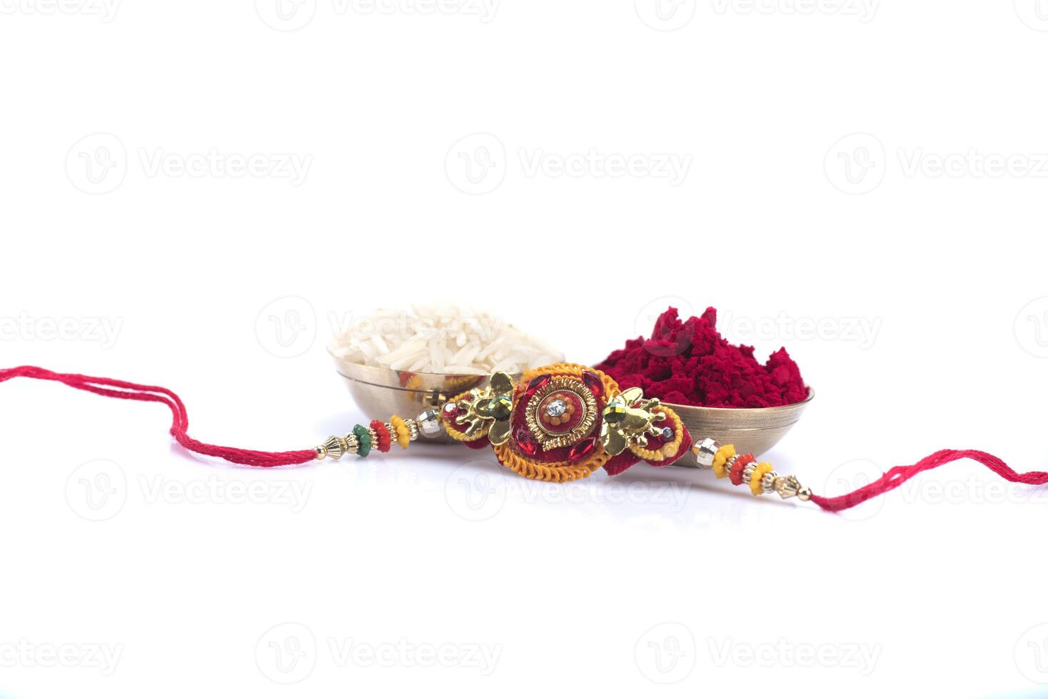 A rakhi with red and white flowers on a white background photo