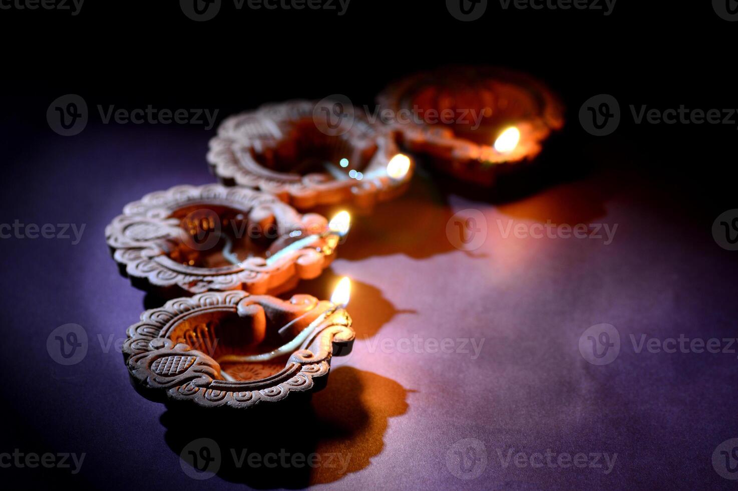 Colorful clay Diya Lantern lamps lit during Diwali celebration. Greetings Card Design Indian Hindu Light Festival called Diwali. photo